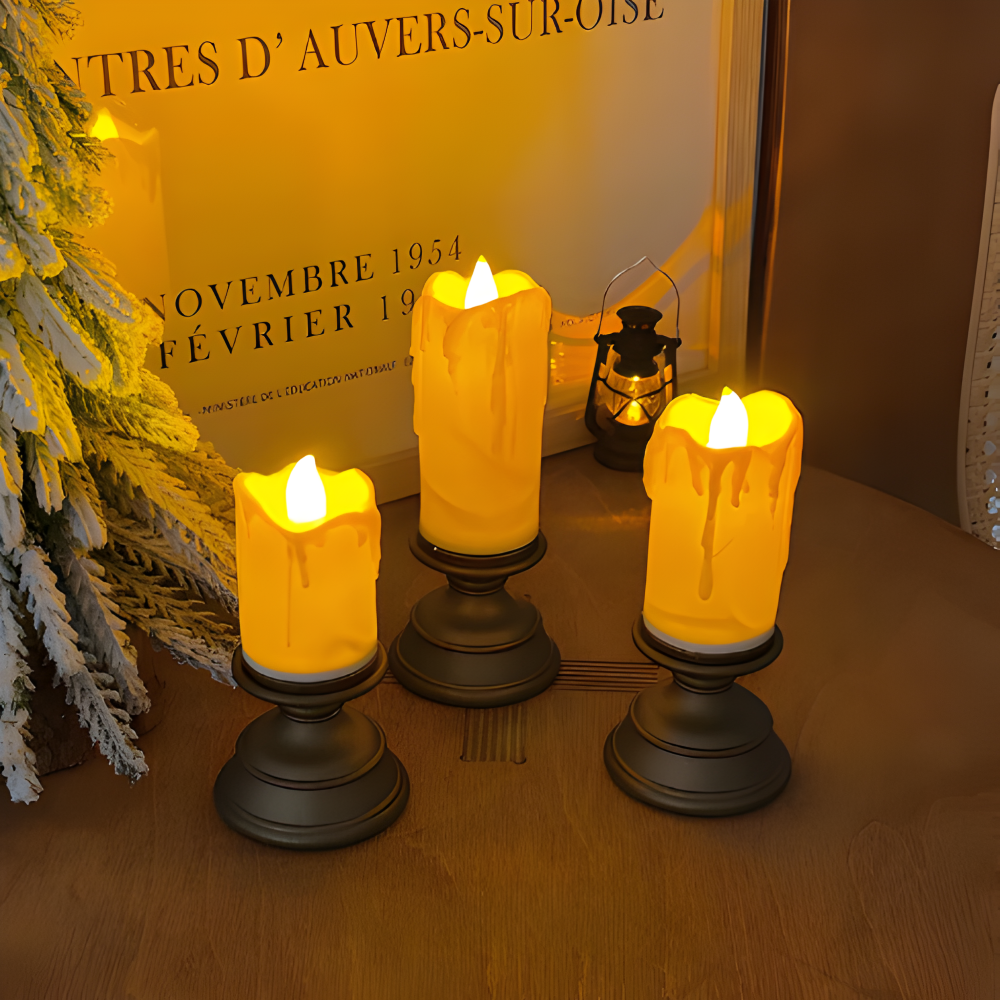 Three lit candles on stands with a decorative background