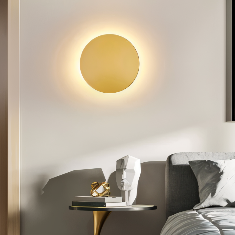 Modern wall lamp with a gold circular design on a neutral wall.