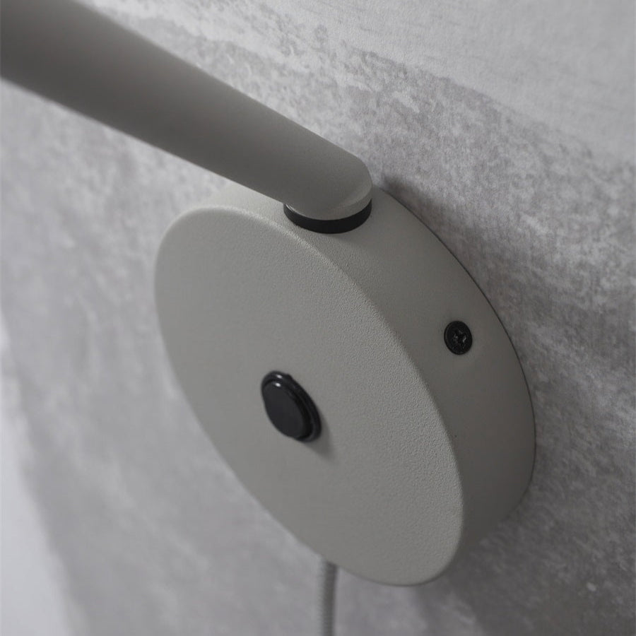 White wall-mounted light fixture with a grayish background