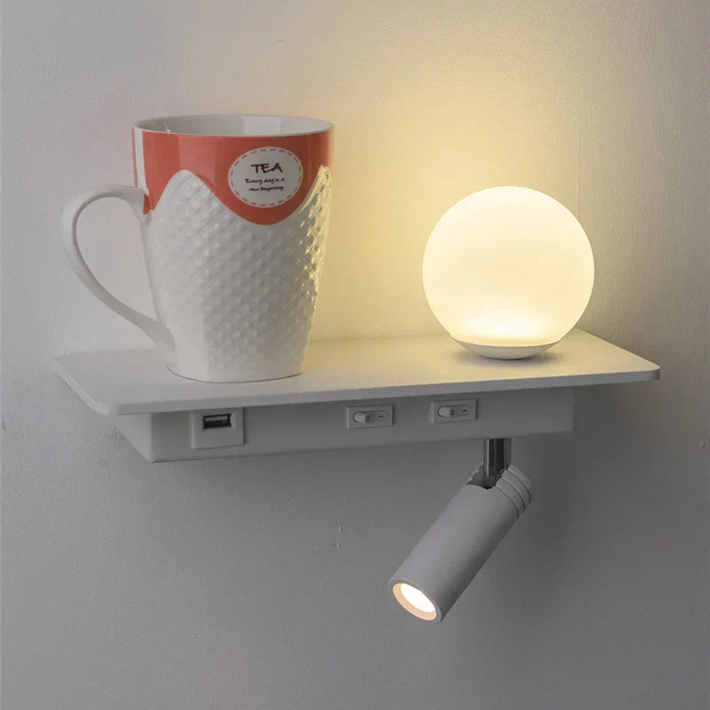 Wall-mounted shelf with a mug and small lamp on a plain background