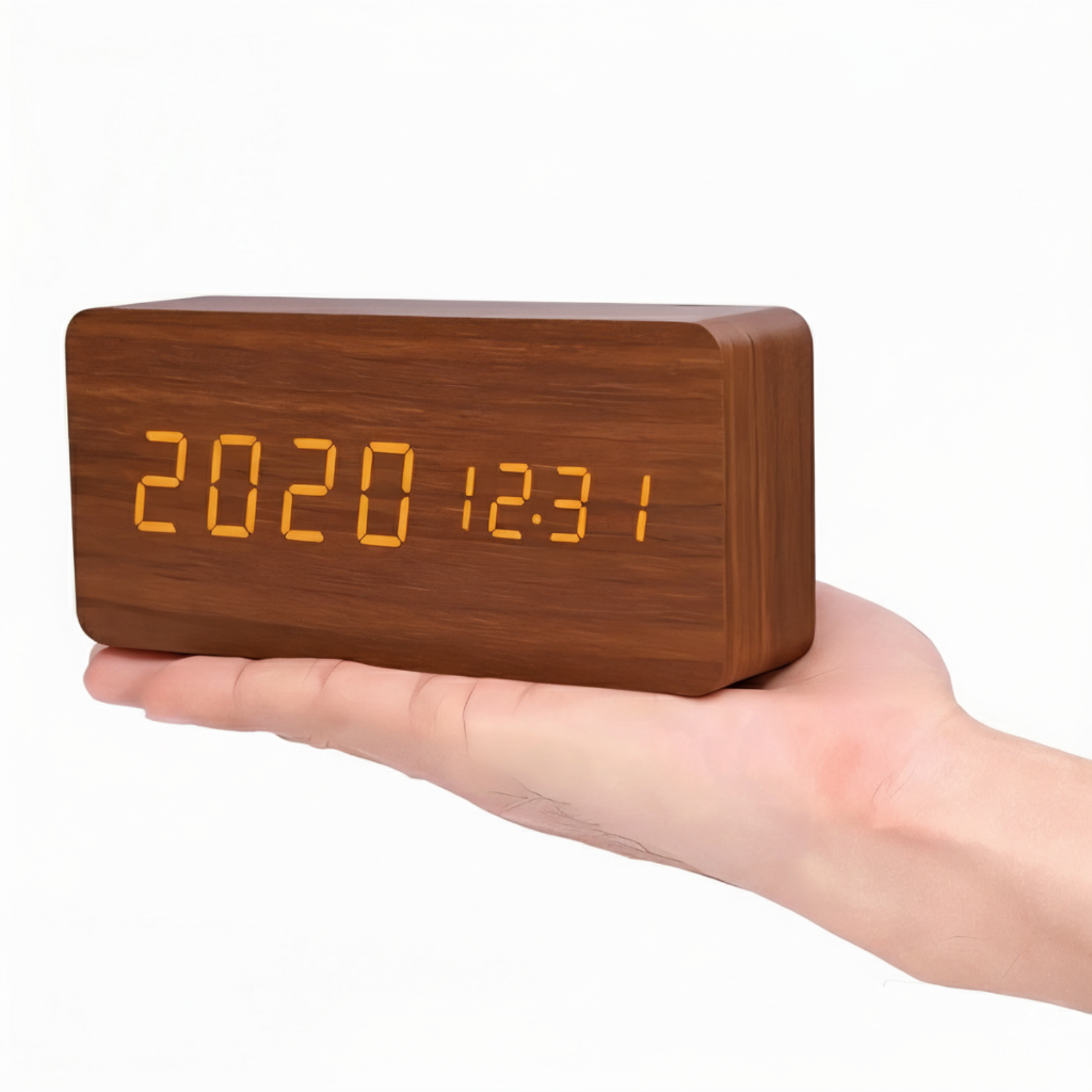 Wooden digital clock with orange LED display held in a hand on a white background