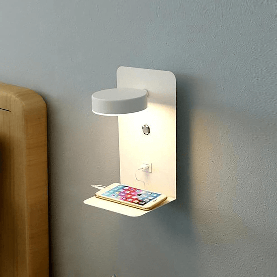 Wall-mounted night light with phone charging station on a gray wall.