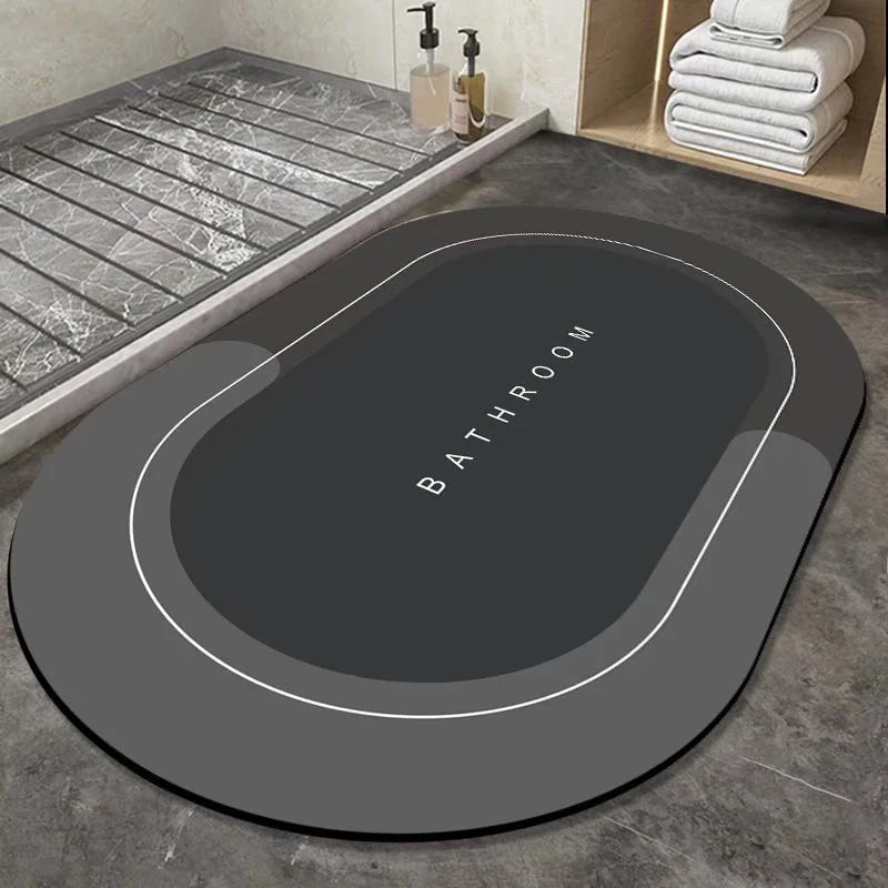 Gray bath mat with 'Bathroom' text on a bathroom floor.