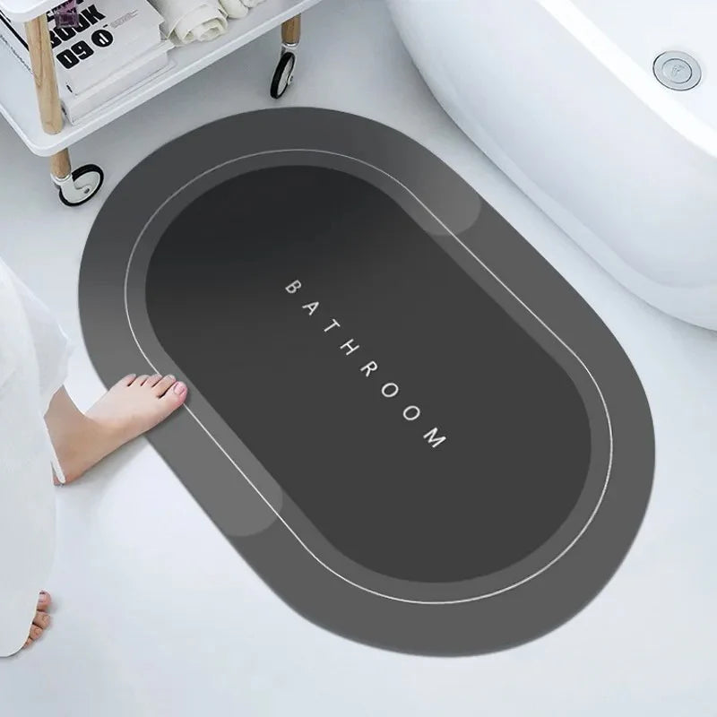 Gray bath mat with 'Bathroom' text on a white bathroom floor.