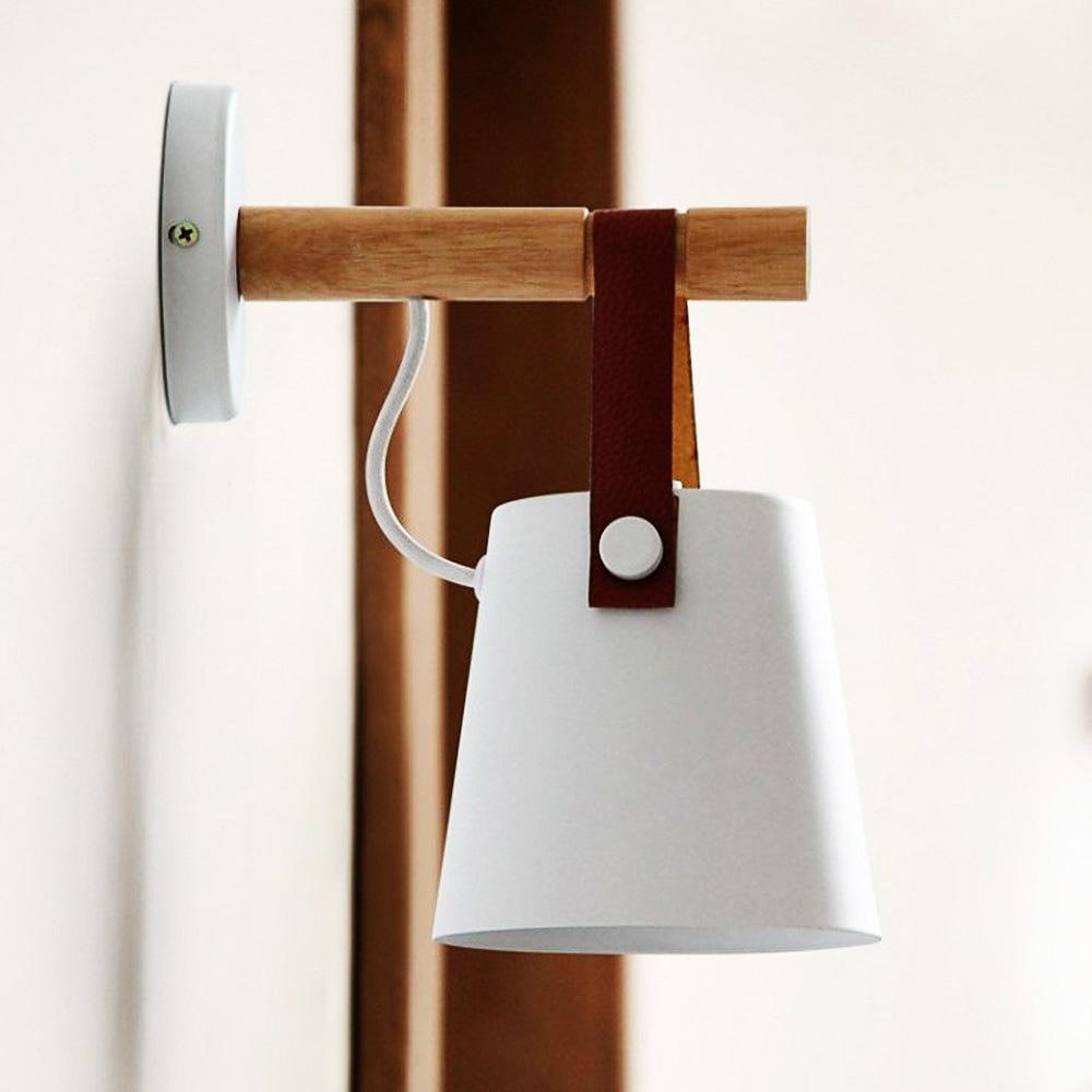 Wall-mounted lamp with wooden bracket and white shade on a neutral background