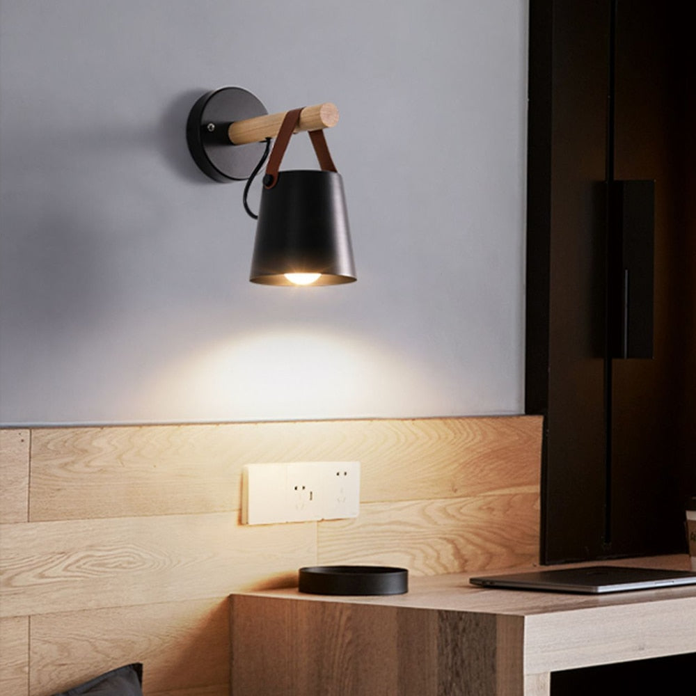 Modern wall lamp with wooden accent on a light gray wall.