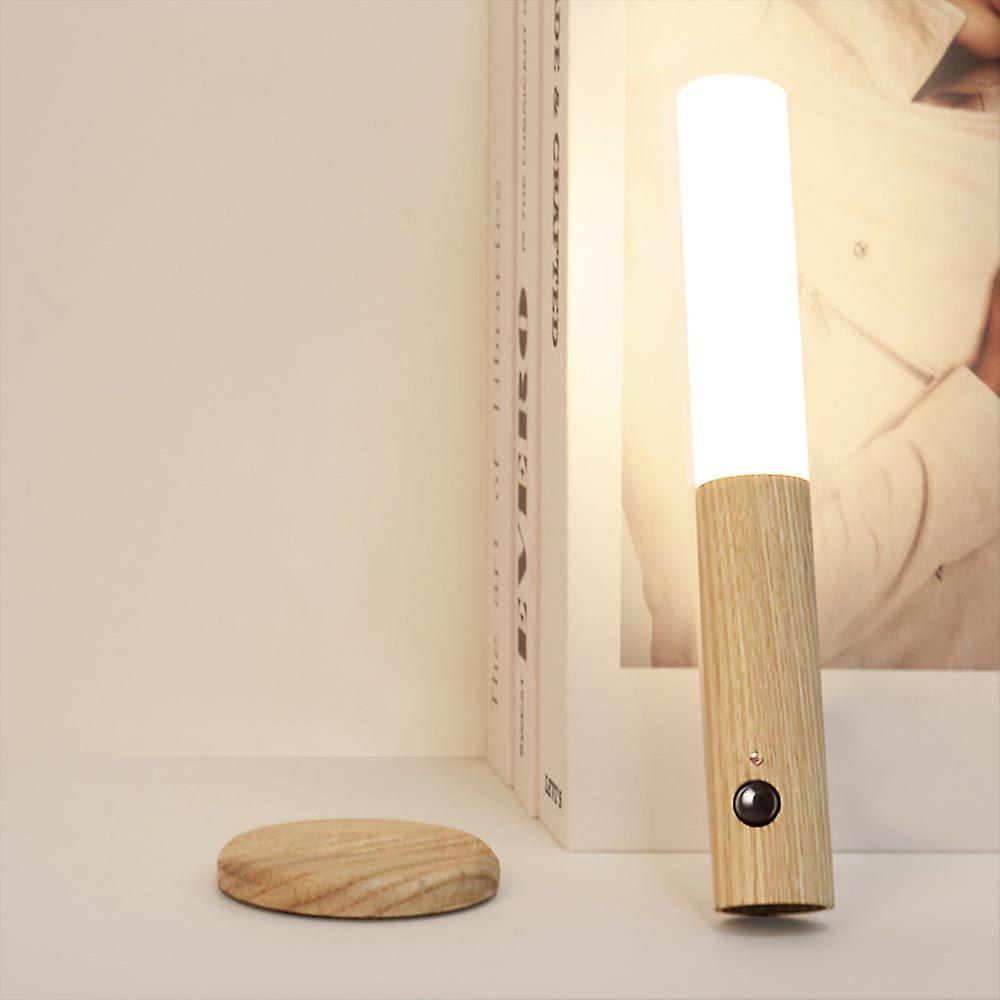 Wooden lamp with a light bulb on a white surface