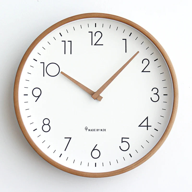 Wall clock with wooden frame and white face on a light background