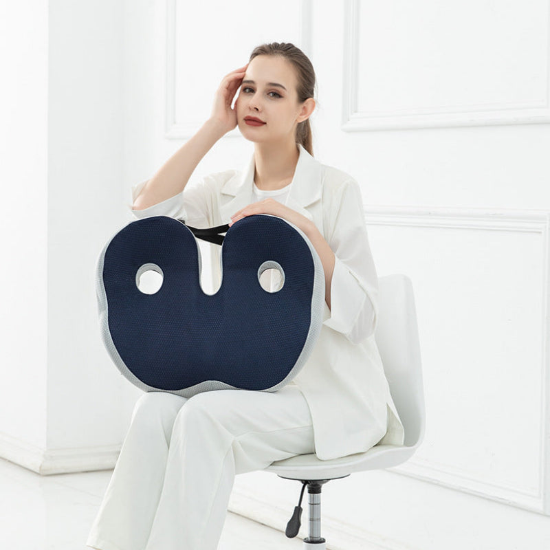 Woman sitting on a chair with a blue neck and shoulder massager.