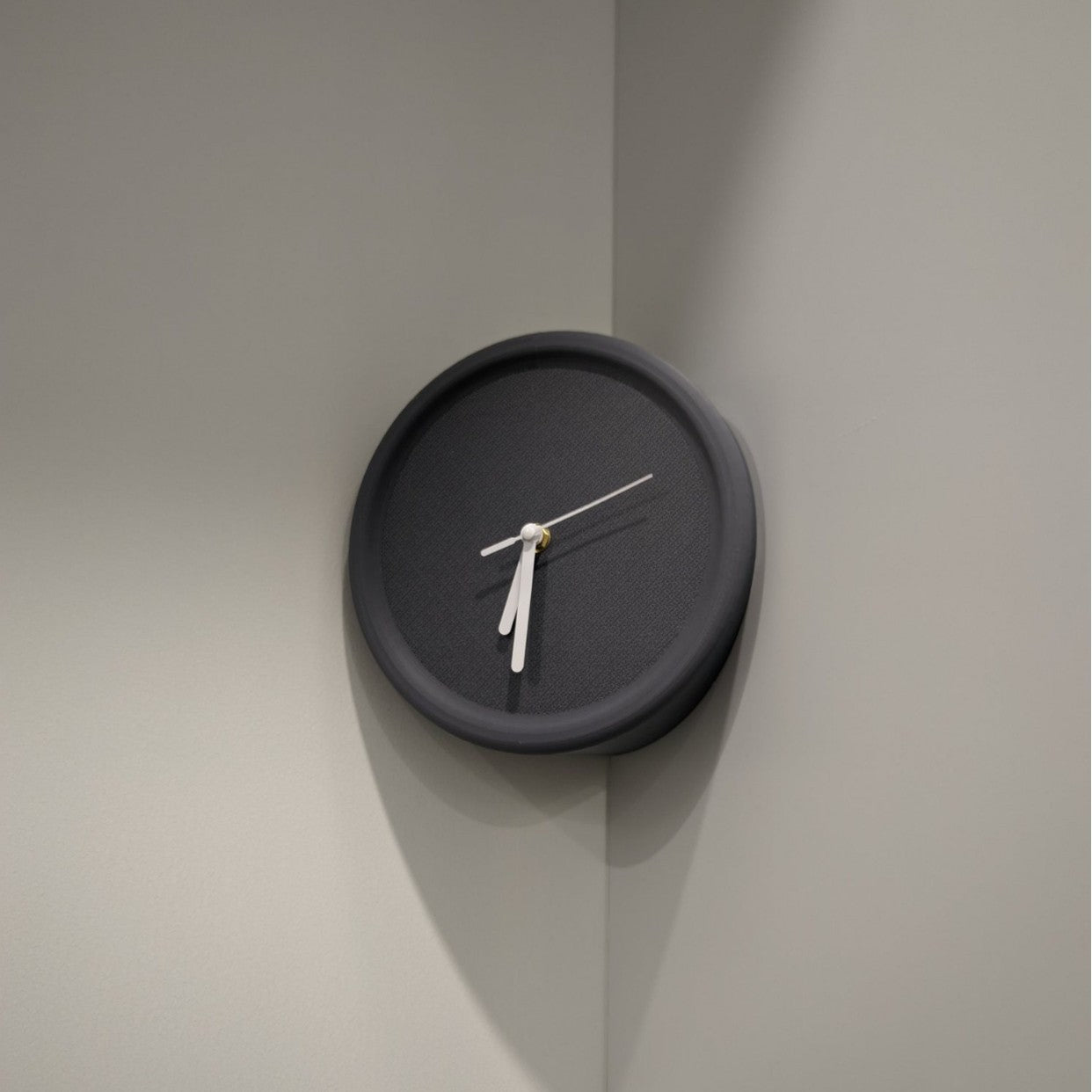 Black wall clock on a gray wall