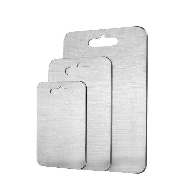 Three metallic cutting boards of different sizes on a white background