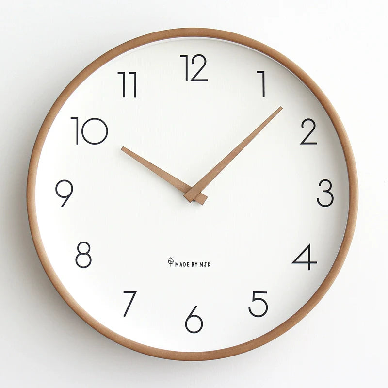 Wall clock with wooden frame and white face on a light background