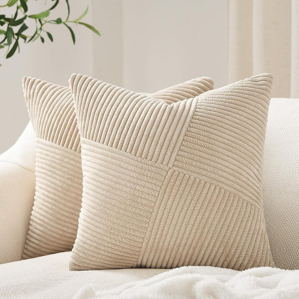 Beige textured pillows on a sofa with a neutral background