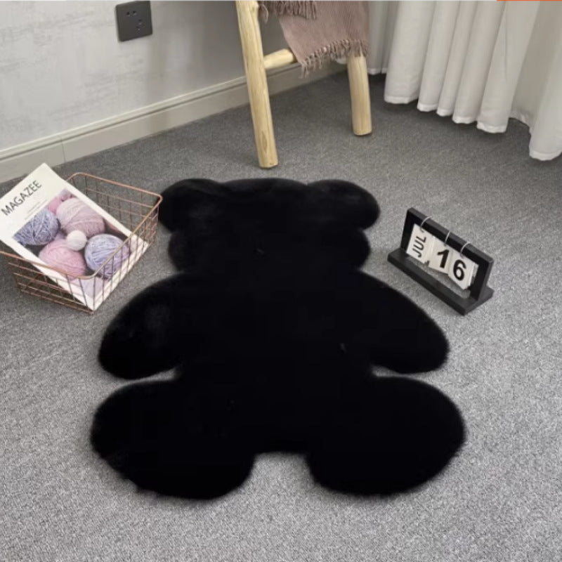 Black teddy bear-shaped rug on a gray carpet with a chair and basket in the background.