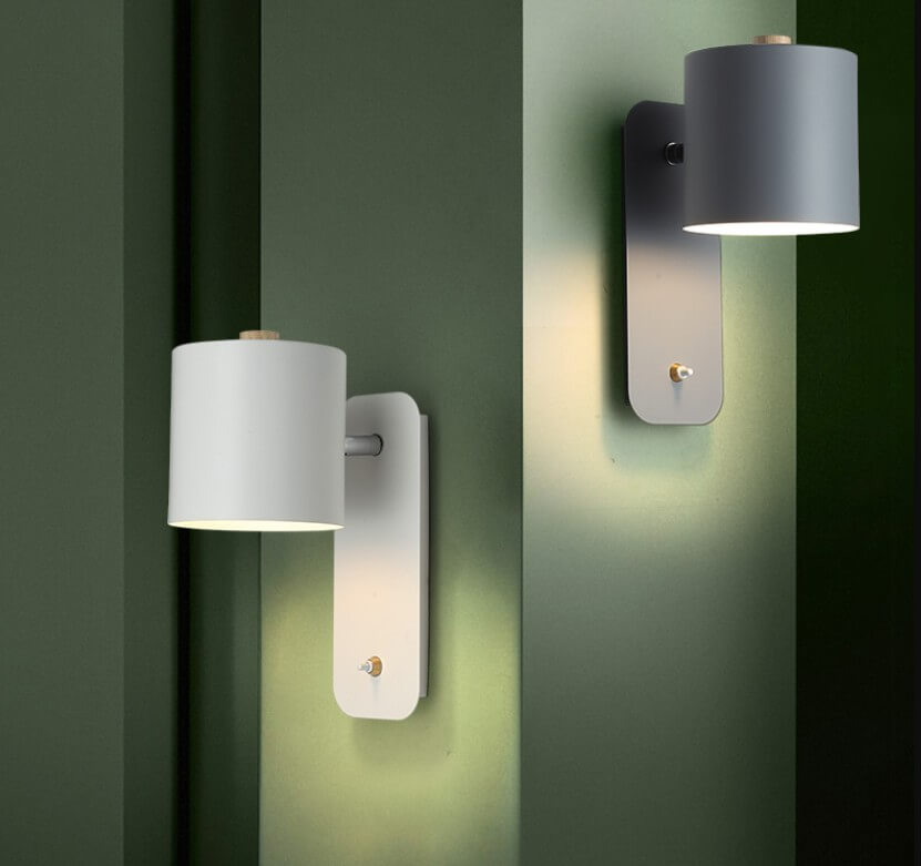 Two wall-mounted lights on a green wall