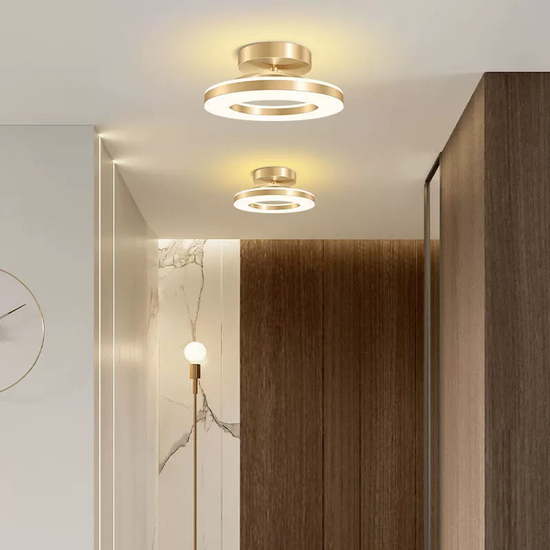 Modern ceiling lights in a room with wooden paneling and a clock.