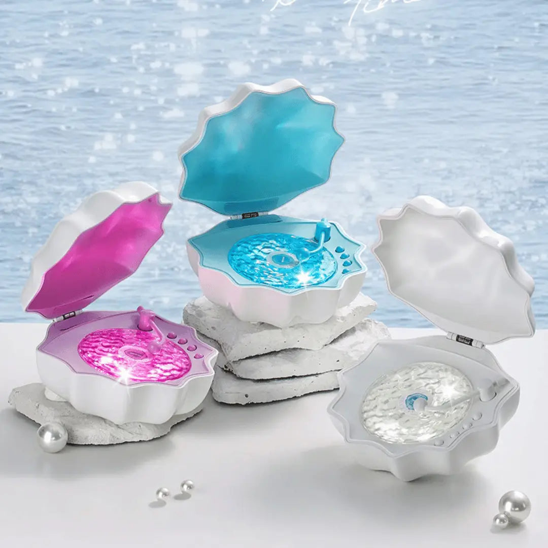 Three shell-shaped jewelry boxes with colorful interior compartments on a light blue background.