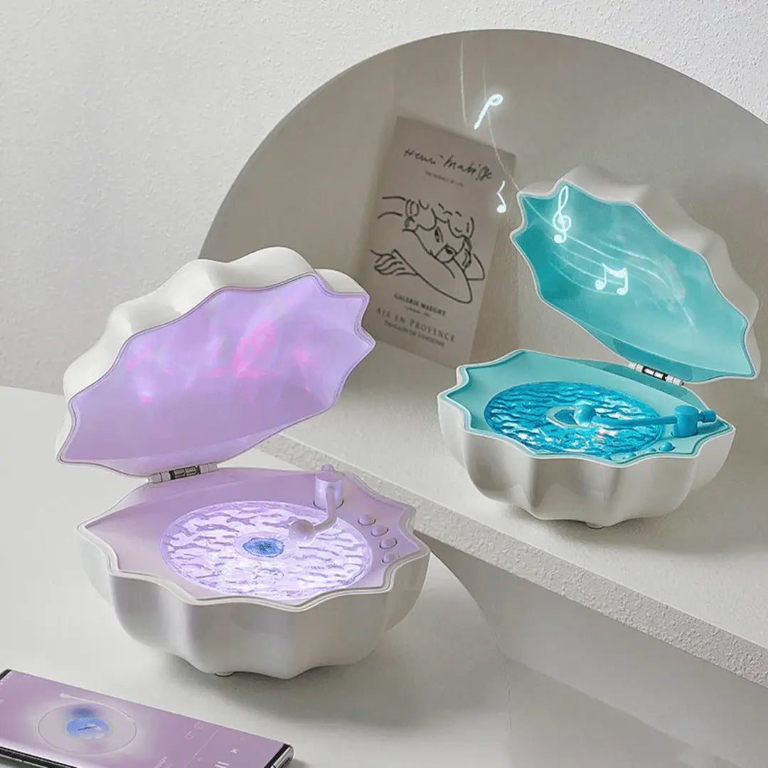 Two shell-shaped jewelry boxes, one purple and one blue, on a white surface with a white wall background.