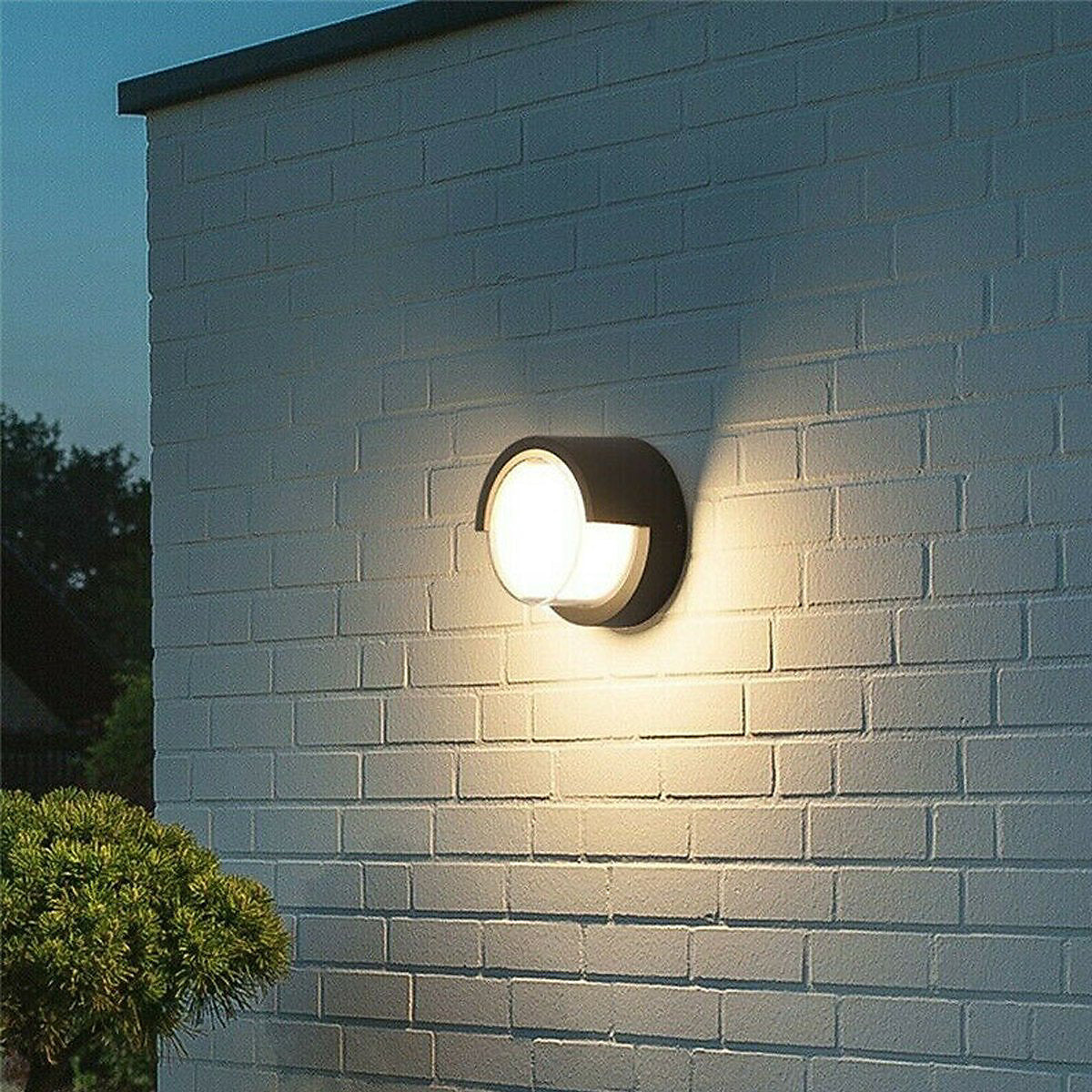 Outdoor wall light fixture on a brick wall with a blurred background