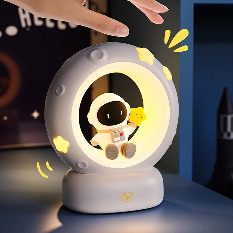 Cute astronaut night light with a yellow duckling, glowing softly.