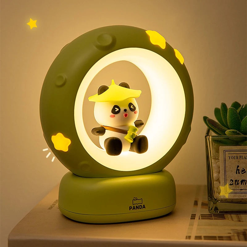 Cute panda night light with a moon design on a table.