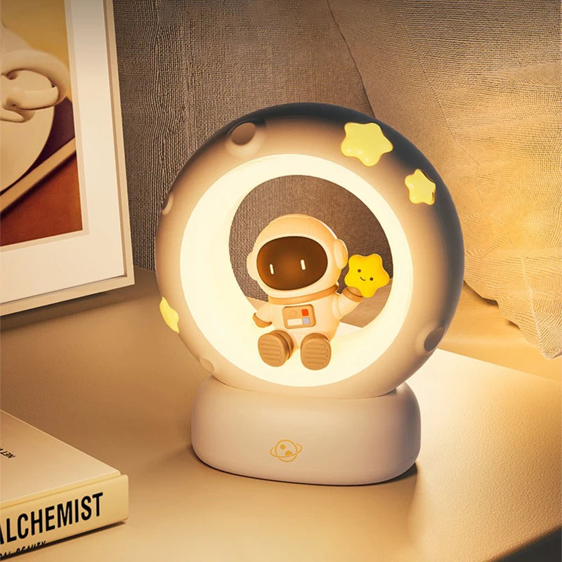 Cute night light with an astronaut design on a bedside table.