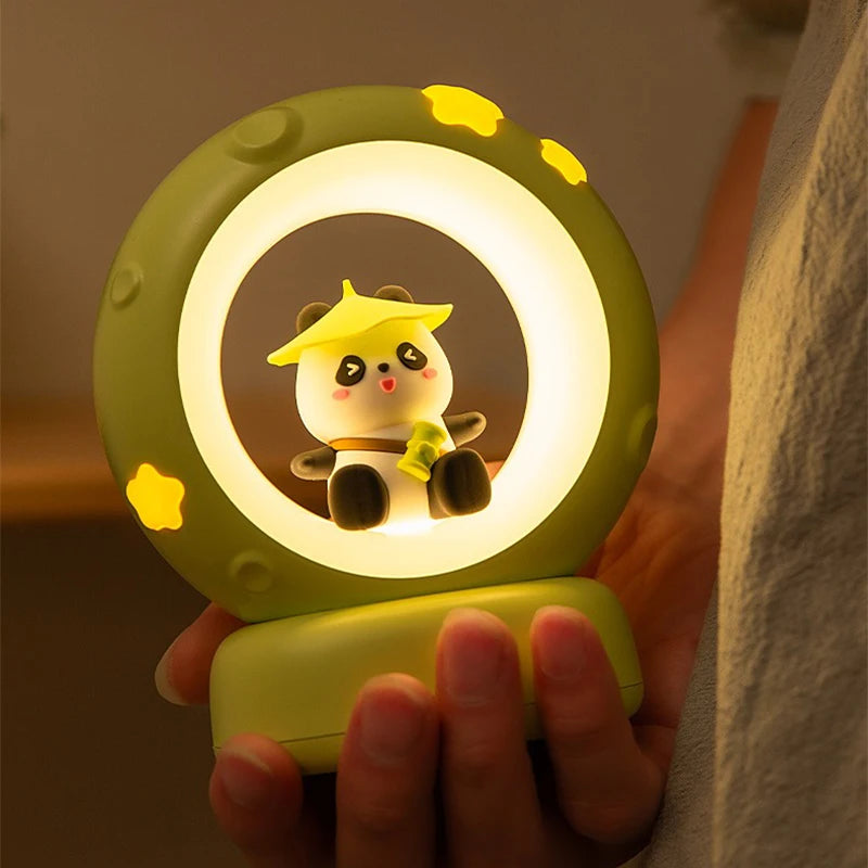 Cute character night light held in a hand with a warm glow
