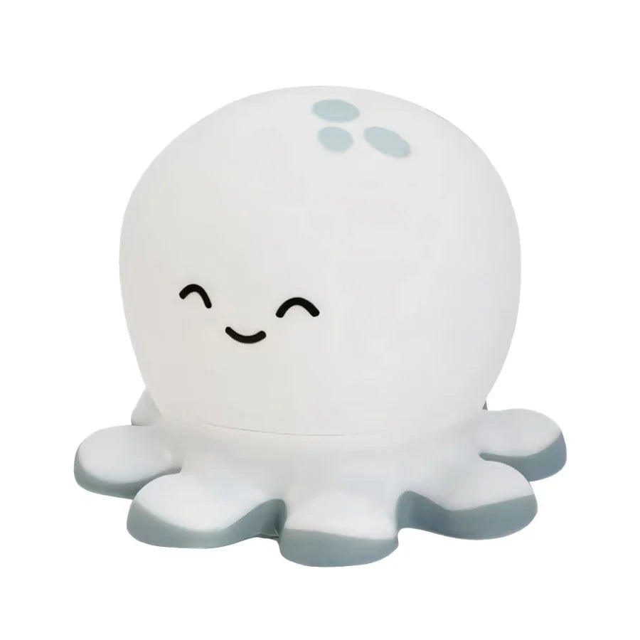 White octopus-shaped night light with a smiling face on a white background