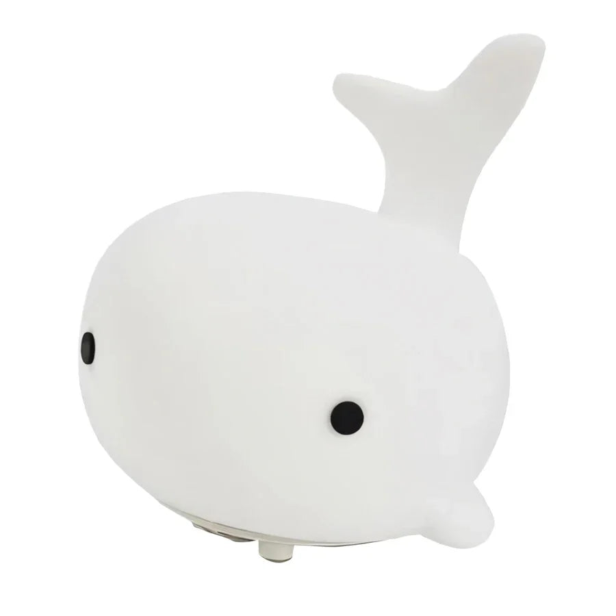White whale-shaped night light on a white background