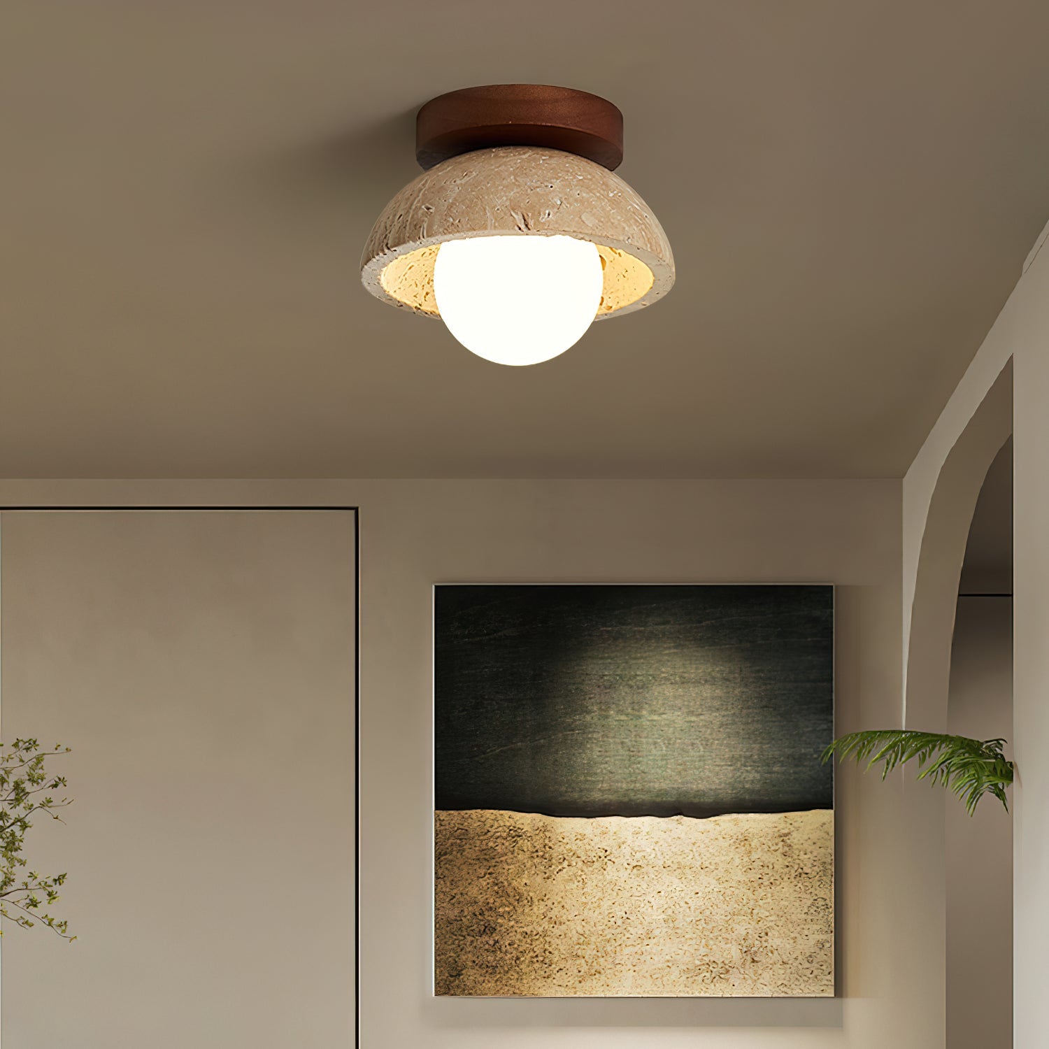 Ceiling light fixture in a room with a painting on the wall