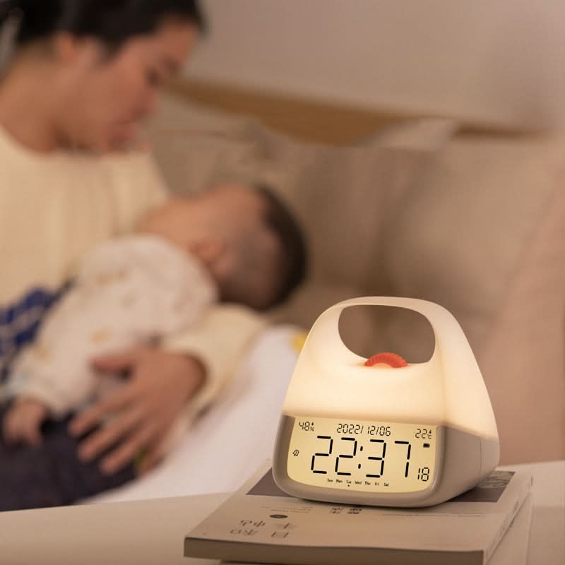 Digital clock on a nightstand with a blurred background of a person sleeping.