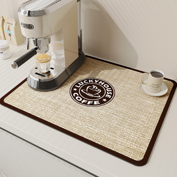 Coffee mat with Luckyhouse Coffee logo next to an espresso machine and cup on a white surface.