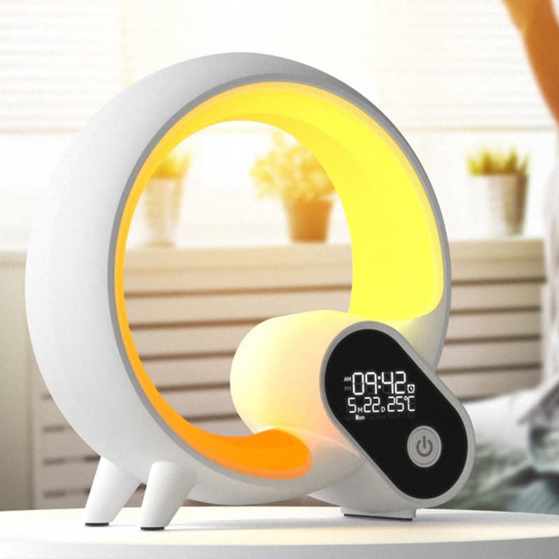 White and yellow digital clock with a display on a blurred indoor background