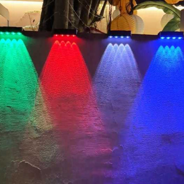 Colorful LED lights on a stone wall with a blurred indoor background