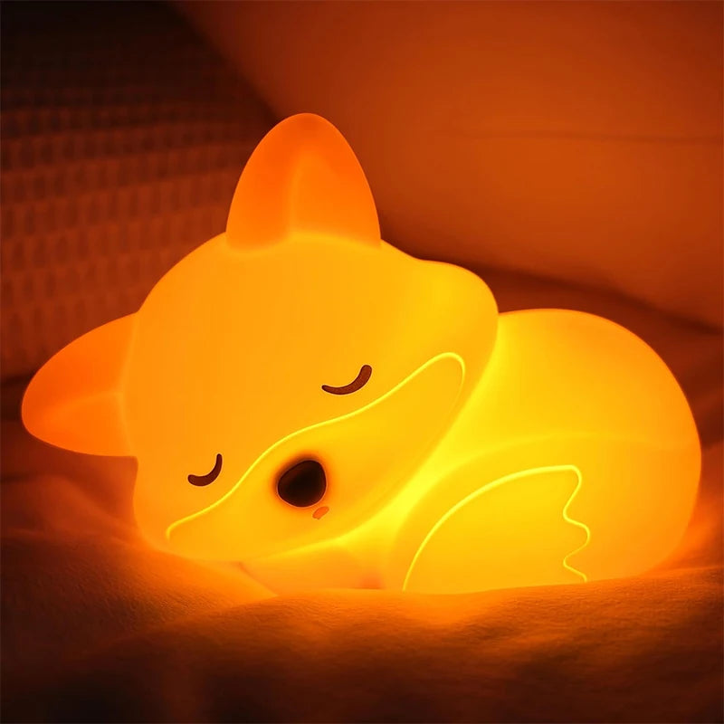 Glowing yellow fox-shaped night light on a dark background