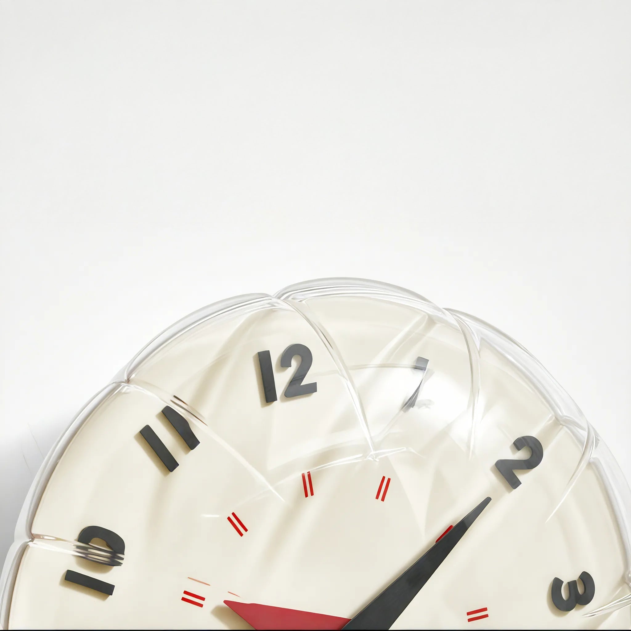 Round clock with a white face, black numbers, and red accents on a light gray background