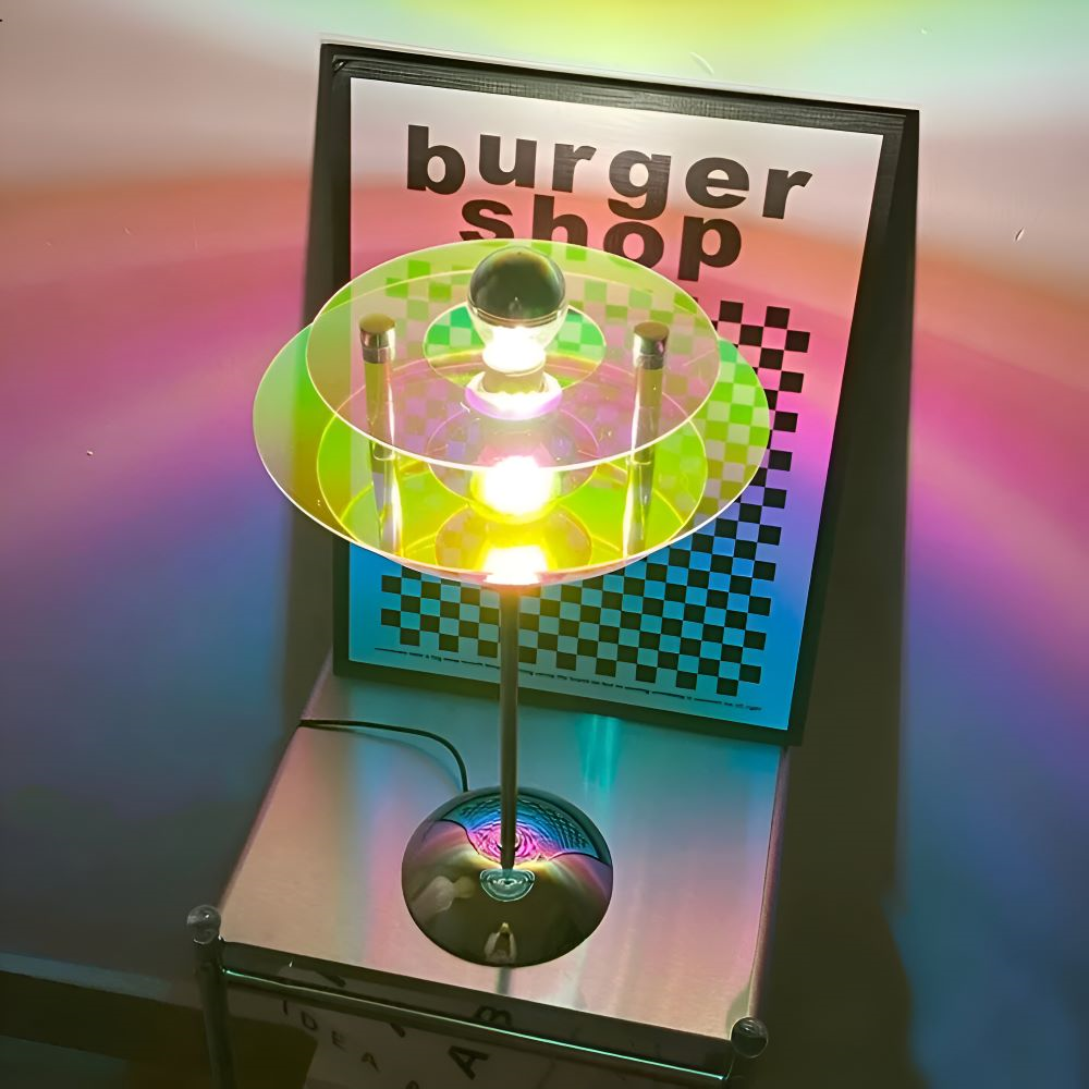 Colorful light fixture on a stand with 'burger shop' sign in the background