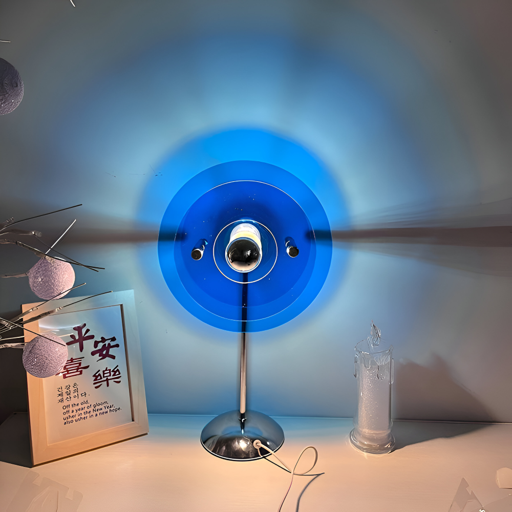 Modern table lamp with blue circular design on a white surface