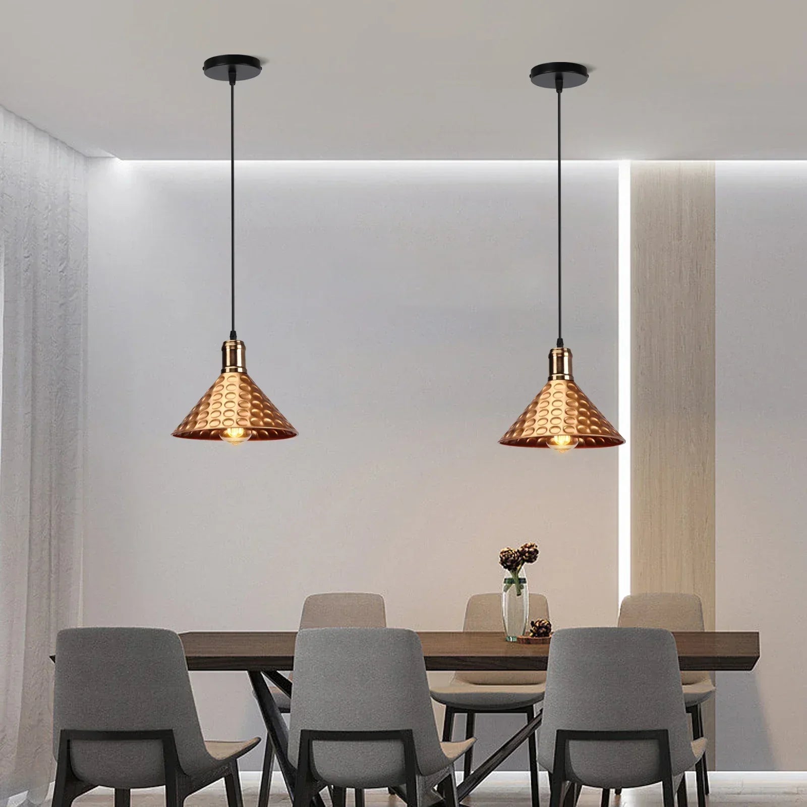 Modern dining room with pendant lights and a table.