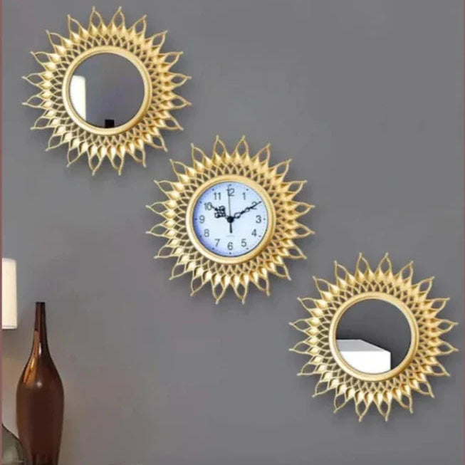 Decorative gold wall clock and mirrors on a gray wall