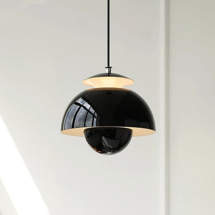 Modern pendant light with black and gold design on a white background