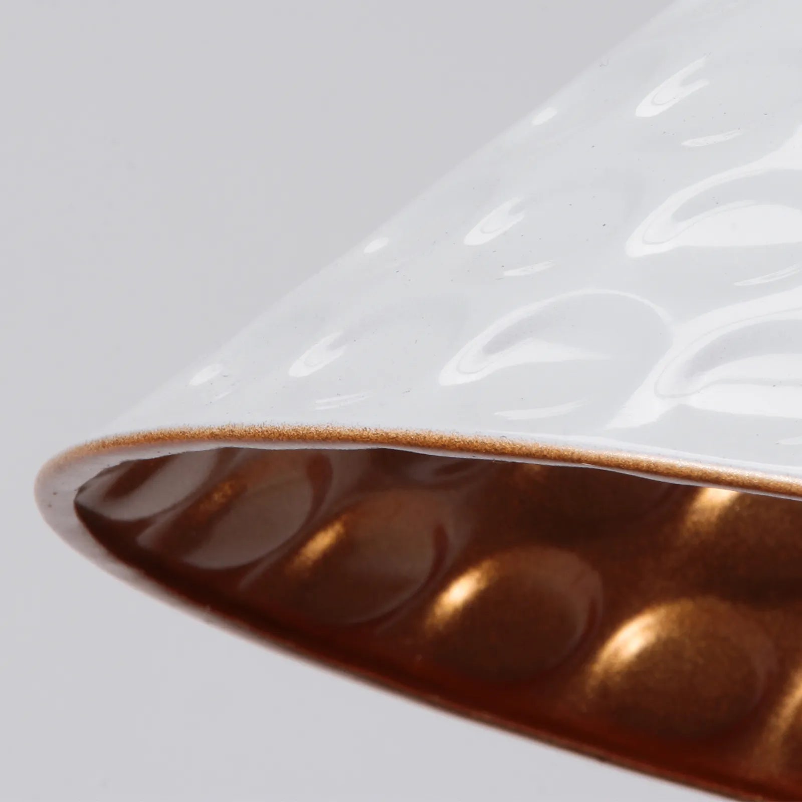 Close-up of a textured white surface with a brown border on a light gray background