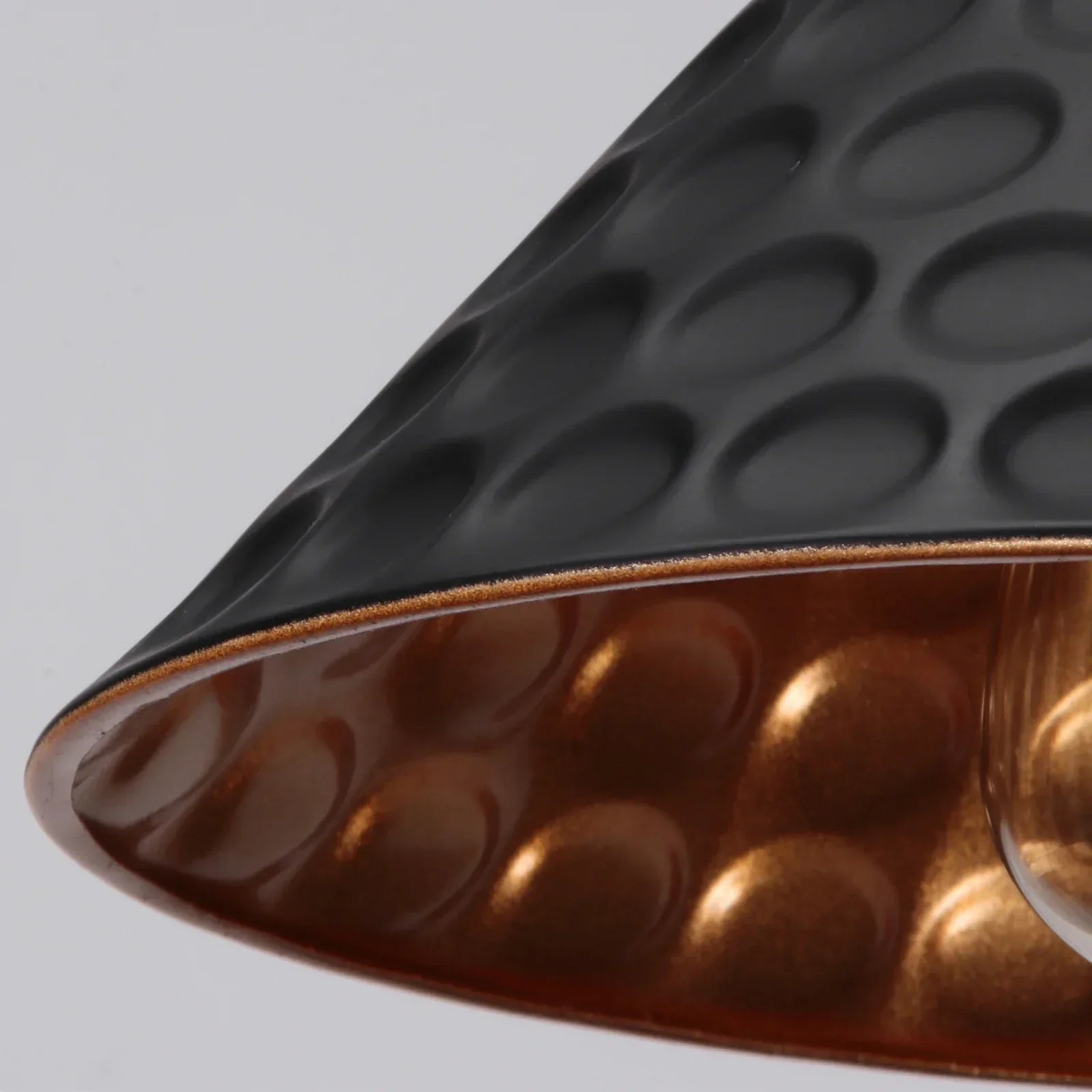 Close-up of a textured black and brown object on a light gray background