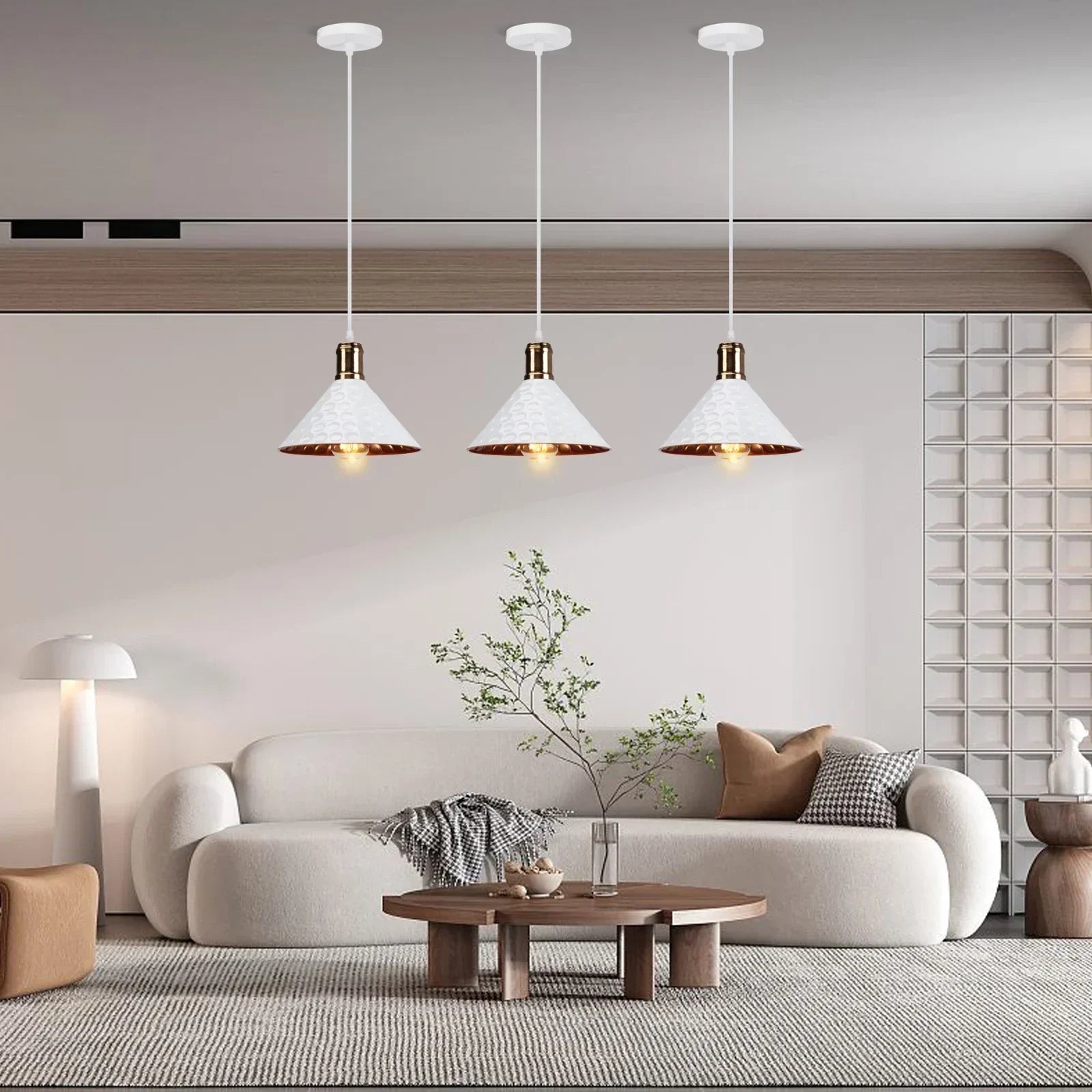 Modern living room with a white sofa, wooden coffee table, and pendant lights.