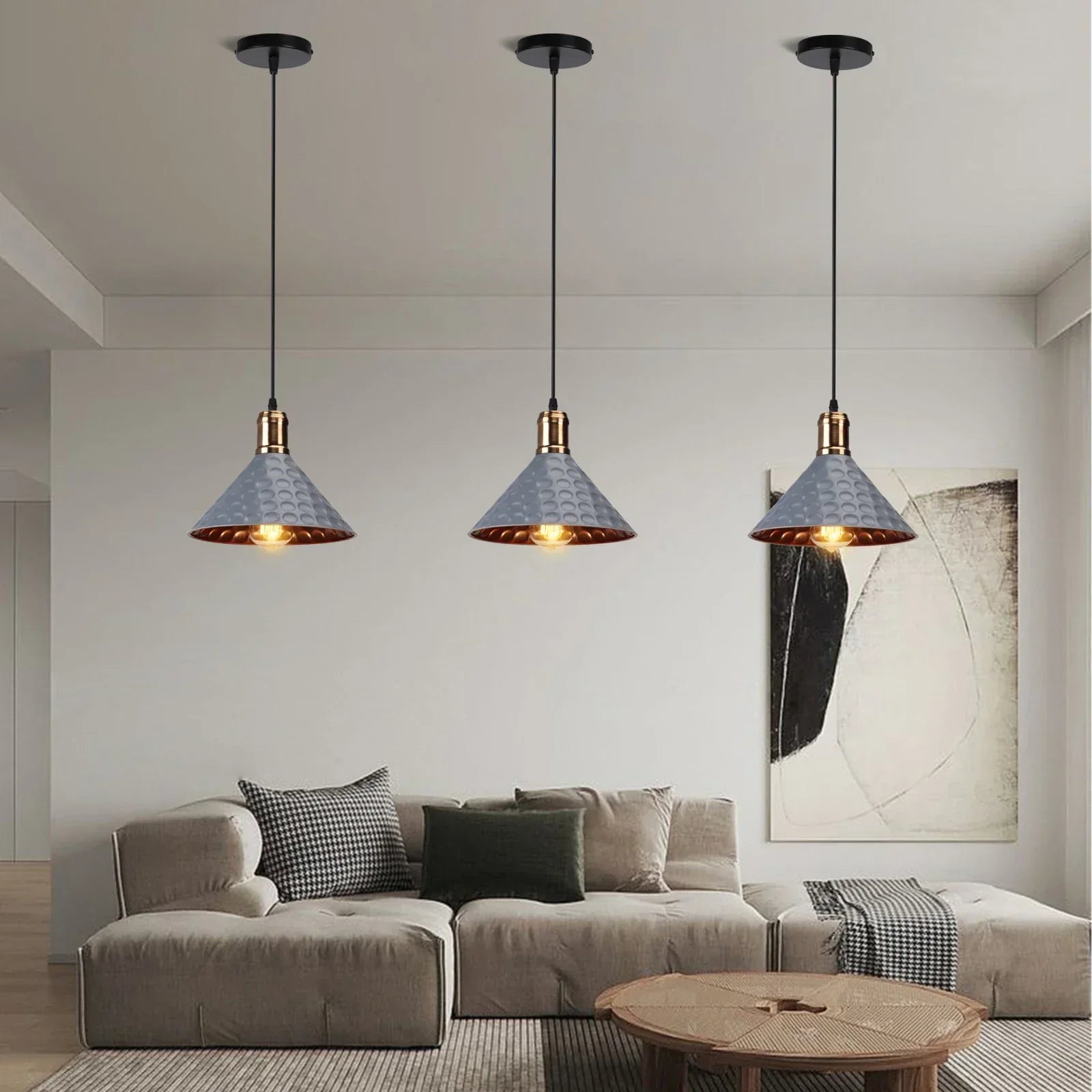 Three pendant lights hanging above a sofa in a living room.