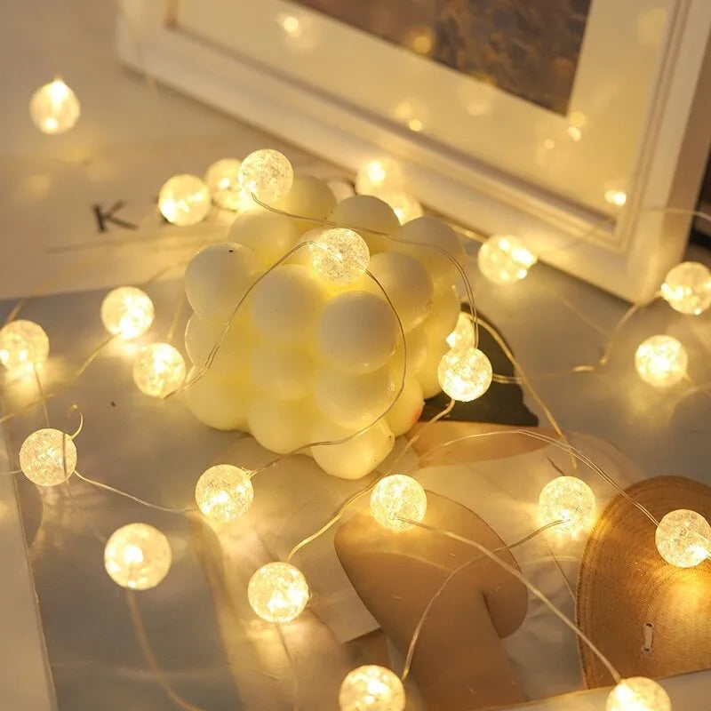 String of lights with round bulbs on a surface with a blurred background