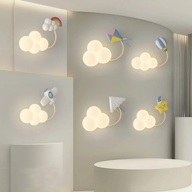 Children's room wall lights with cloud and kite designs on a light gray wall.