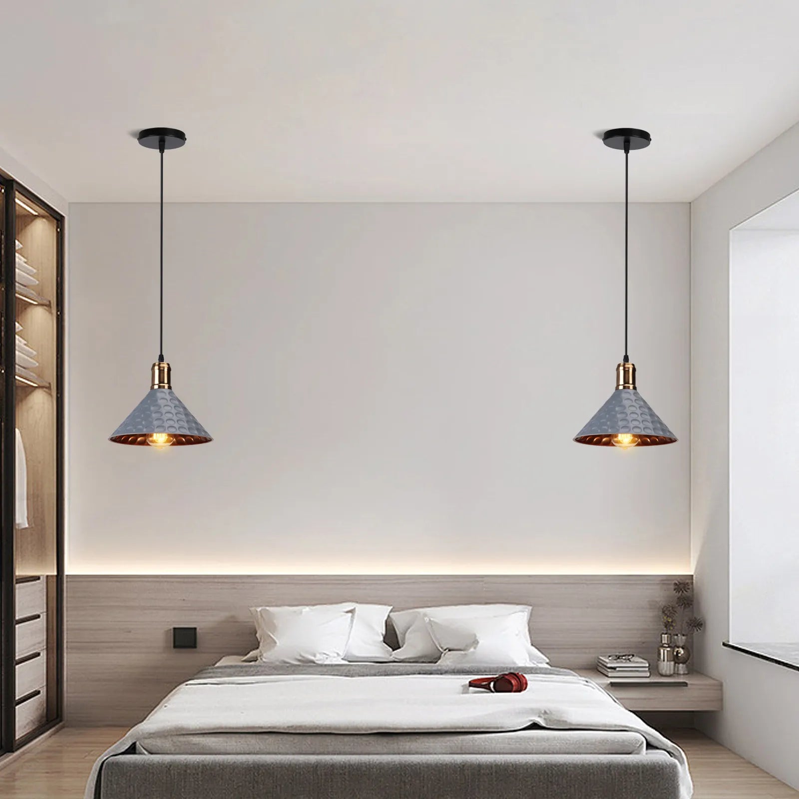 Modern bedroom with pendant lights and neatly made bed