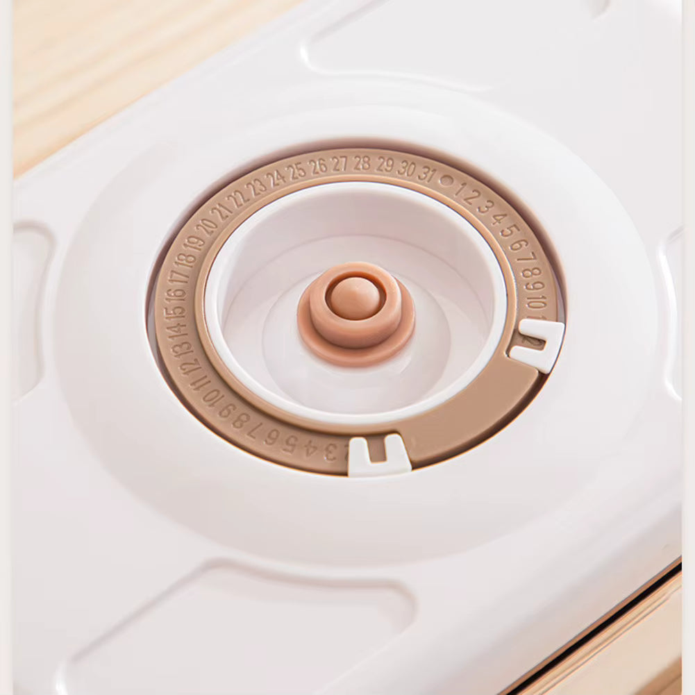 Close-up of a white and beige container with a circular lid on a light wooden surface.