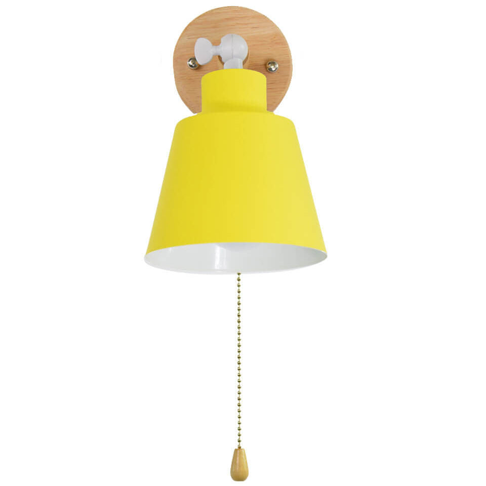 Yellow wall lamp with wooden pull chain on a white background